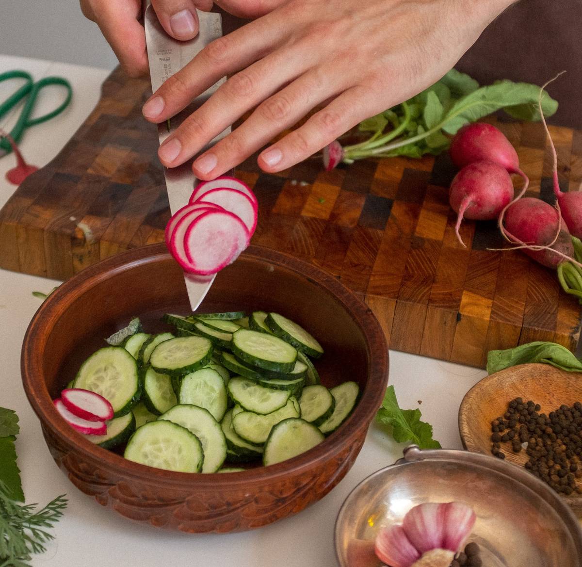 multi vegetable cutter on wooden cutting board with diced carrots and onions